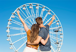 back-view-couple-watching-fun-wheel.Featured image